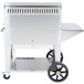 A large stainless steel Crown Verity barbecue grill with wheels.
