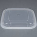 A Pactiv Newspring VERSAtainer black plastic container with a clear plastic lid.