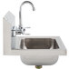 An Advance Tabco stainless steel hand sink with a splash mount faucet and wrist handles.