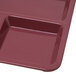 A dark cranberry melamine tray with four compartments.