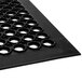 A black Notrax anti-fatigue rubber floor mat with holes.
