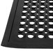 A black rubber mat with holes.