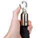 A hand holding a black metal stanchion rope end with a metal hook.
