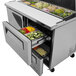 A Turbo Air stainless steel refrigerated sandwich prep table with a drawer full of food.
