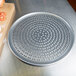 An American Metalcraft Super Perforated Heavy Weight Aluminum Coupe Pizza Pan with holes in it.