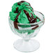 A green ice cream with chocolate syrup in a Libbey Sherbet Glass.