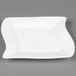 A CAC Miami square white porcelain plate with a curved edge.