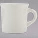 A white Tuxton china coffee mug with a handle.