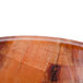 A close-up of a Thunder Group woven wood salad bowl with a wood surface.