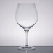 A Stolzle burgundy wine glass on a table.