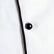 A close up of a white Chef Revival chef coat with black buttons.