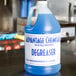 A blue gallon of Advantage Chemicals Concentrated Degreaser on a counter.