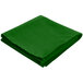 A folded green Intedge square cloth table cover.
