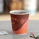 A close-up of a Choice coffee cup with brown liquid and a lid.