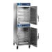 Two stainless steel Alto-Shaam full height cook and hold ovens with doors open.