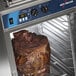 A large piece of meat roasting in an Alto-Shaam full height cook and hold oven.