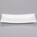A CAC Tokyia bone white rectangular porcelain platter with long edges.