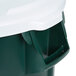 A close-up of a green and white Rubbermaid trash can with a white lid.