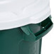 A green Rubbermaid commercial trash can with a white lid.