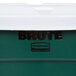 A close-up of a green Rubbermaid BRUTE recycling can with a white lid.