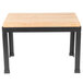 A Tablecraft butcher block riser with a black metal frame on a wooden table with black legs.