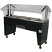 An Advance Tabco stainless steel electric hot food table with an open well on black wheels.