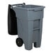 A grey Rubbermaid rectangular trash can with black wheels.