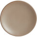 A close-up of a Libbey Driftstone sand satin matte porcelain coupe plate with a white surface.