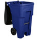 A close-up of a blue Rubbermaid trash can with black wheels and a black handle.