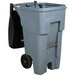 A grey Rubbermaid commercial trash can with black wheels.