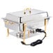 A Vollrath stainless steel chafer with brass trim and a power cord on a table outdoors.