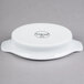 A white porcelain Libbey Reflections rarebit dish with a handle.