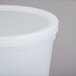 A white translucent plastic round deli container with a lid.