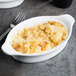 A white Libbey porcelain rarebit dish with macaroni and cheese on top.