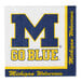 A white Creative Converting napkin with a blue University of Michigan logo and yellow text.