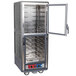 A large metal holding and proofing cabinet with clear Dutch doors open.