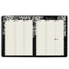 A black and white At-A-Glance planner with floral designs on a white background.