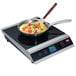 A Hatco countertop induction range with a pan of omelette on it.