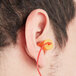 A man wearing a Cordova corded earplug in his ear.