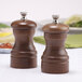 A wooden Chef Specialties pepper and salt mill set on a table.