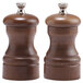 A close-up of a Chef Specialties walnut pepper mill and salt mill set.