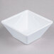 A white square Elite Global Solutions melamine bowl.