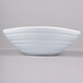 A close up of a white Elite Global Solutions swirl oblong melamine bowl with a white rim.