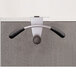 An Alba silver and black metal hanger-shaped coat hook on a wall.