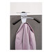 An Alba silver and black coat hook partition with a pink jacket hanging on it.