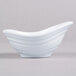 A white oblong melamine sauce dish with a curved edge.
