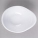 A white oblong melamine sauce dish with a spiral design.