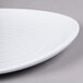 A white plate with a swirl pattern on it.