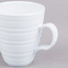 A close-up of a white Elite Global Solutions melamine mug with a handle.