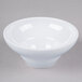 A white Elite Global Solutions melamine bowl with a small rim on a gray surface.